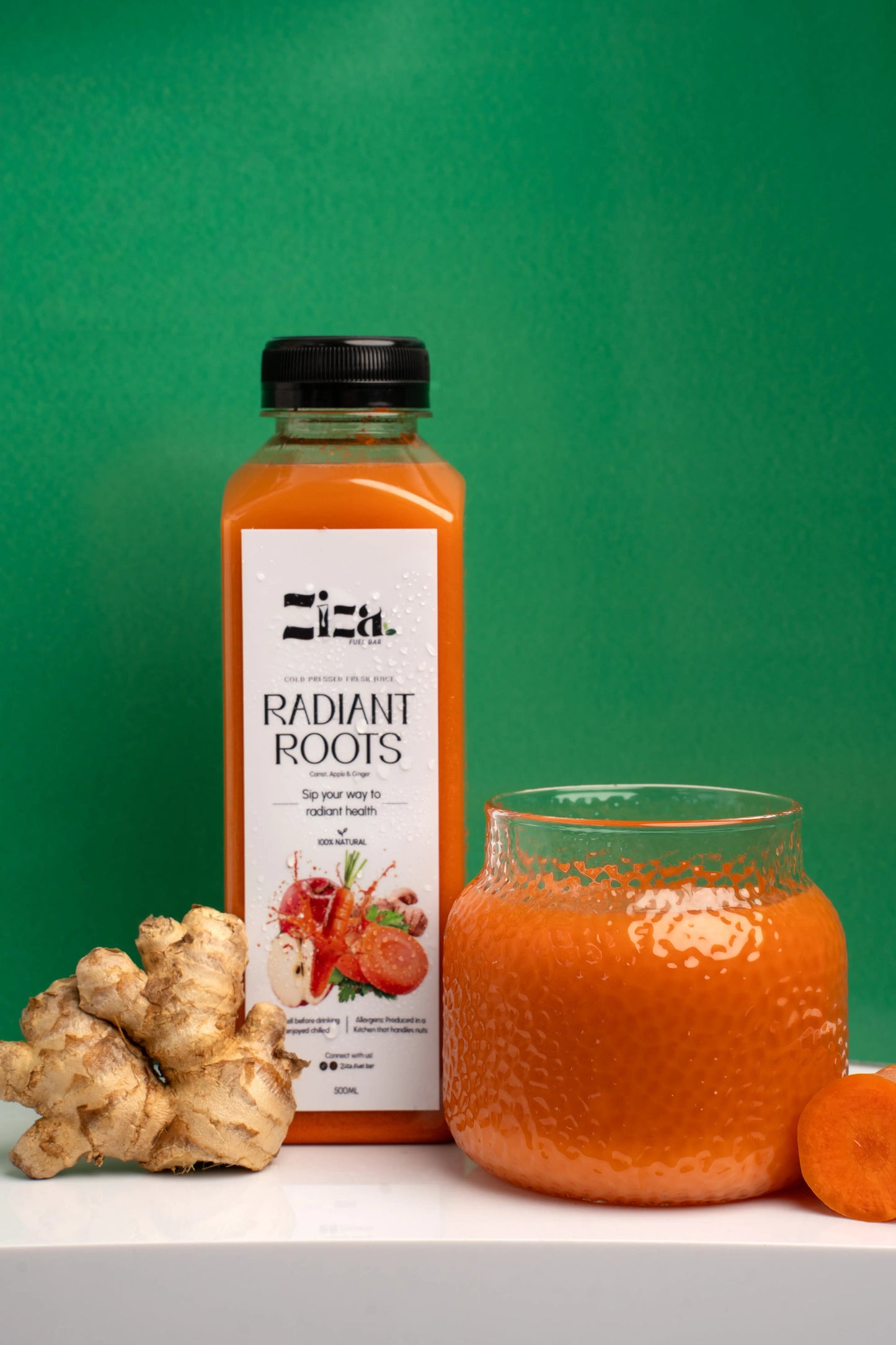Ziza fuelbar Radiant Root cold pressed carrot apple ginger juice UK – drink bottle lifestyle view