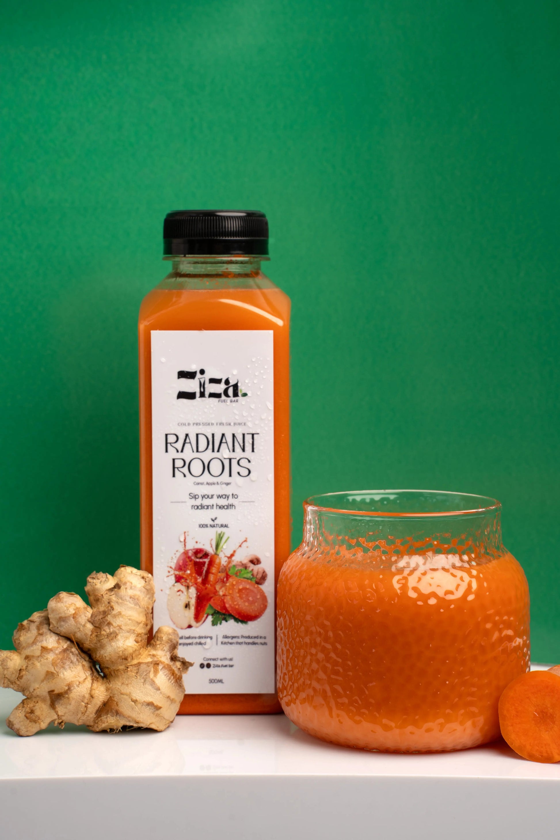 Ziza fuelbar Radiant Root cold pressed carrot apple ginger juice UK – drink bottle lifestyle view